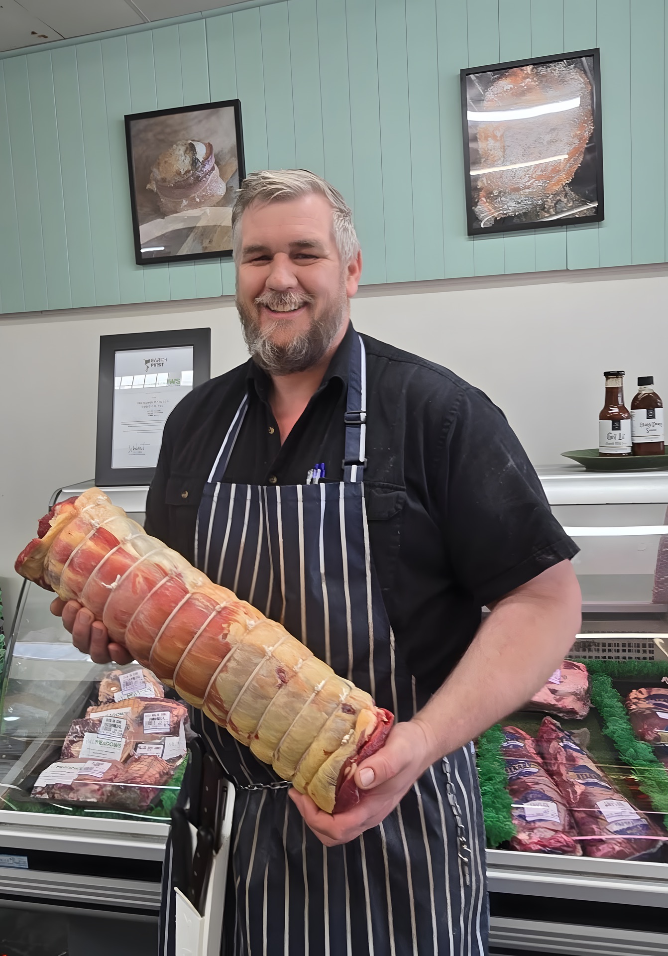 Nick holding a boned and rolled roast in the shop